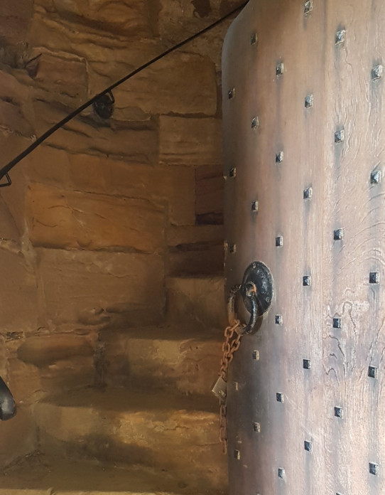 Wood doorway and stone spiral staircase